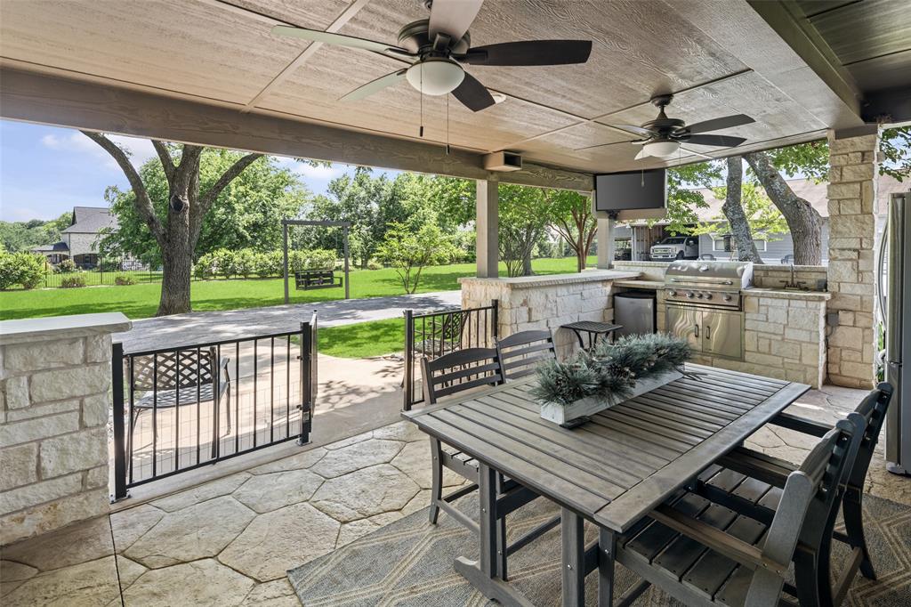 1814 Stacy Road Fairview, TX 75069 - Photo 24 of 36 a view of a patio with a table chairs and a backyard