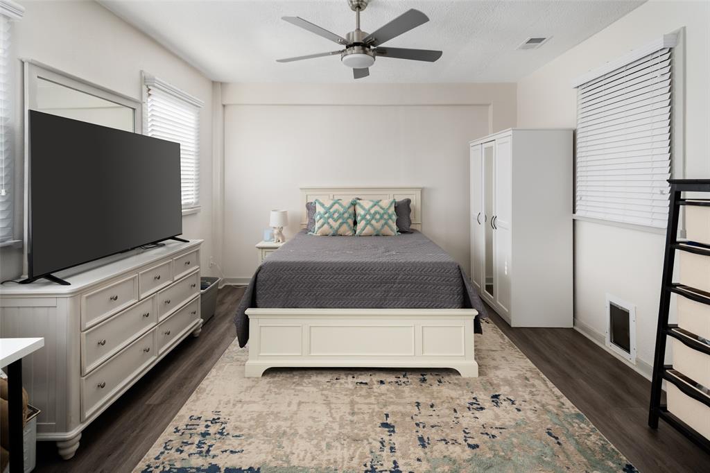 1814 Stacy Road Fairview, TX 75069 - Photo 33 of 36 a white bed sitting in a bedroom and flat screen tv