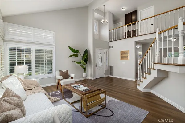 a living room with furniture a window and wooden floor