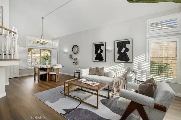 a living room with furniture a table and a large window