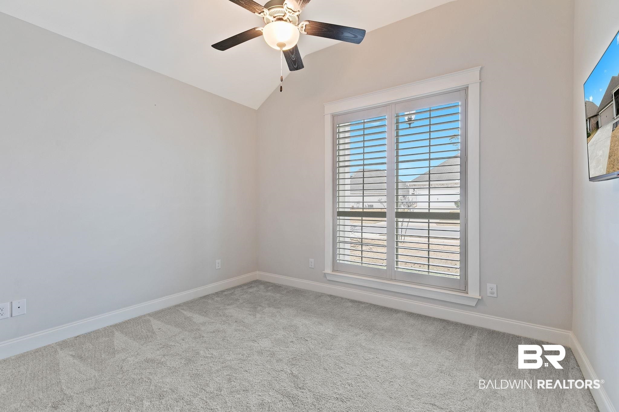 31654 Canopy Loop Daphne, AL 36527 - Photo 37 of 64 Spare room with light carpet, vaulted ceiling, and a ceiling fan