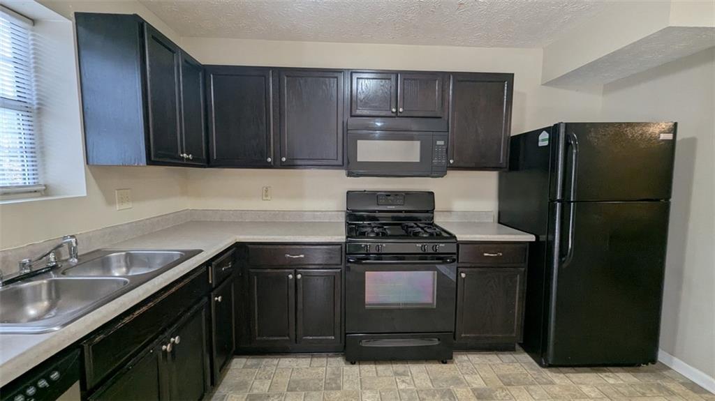 3699 Oakwood Manor Court Decatur, GA 30032 - Photo 11 of 21 a kitchen with a sink stove and refrigerator