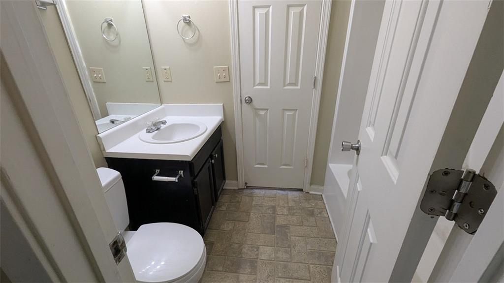 3699 Oakwood Manor Court Decatur, GA 30032 - Photo 16 of 21 a bathroom with a sink a toilet a mirror and vanity