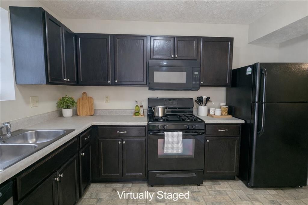 3699 Oakwood Manor Court Decatur, GA 30032 - Photo 4 of 21 a kitchen with a sink a stove and refrigerator