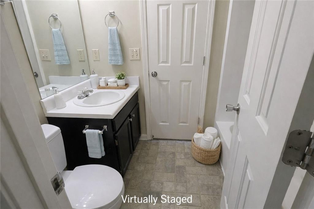 3699 Oakwood Manor Court Decatur, GA 30032 - Photo 6 of 21 a bathroom with a sink a toilet and shower curtain