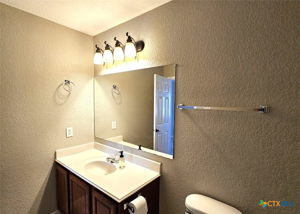 316 Julian Point Cibolo, TX 78108 - Photo 16 of 28 a bathroom with a sink mirror and toilet