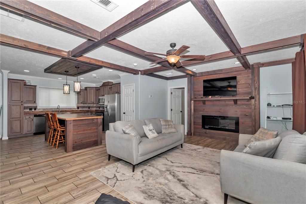 7565 Dewey Robbins Road Howey-in-the-Hills, FL 34737 - Photo 18 of 42 a living room with furniture and a fireplace