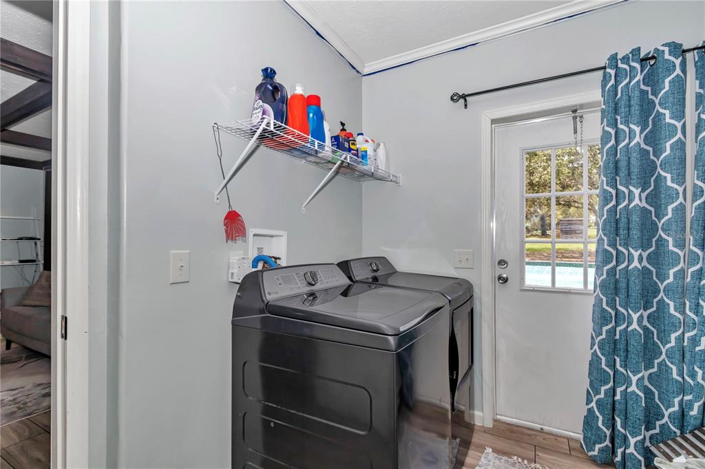 7565 Dewey Robbins Road Howey-in-the-Hills, FL 34737 - Photo 19 of 42 a utility room with dryer and washer