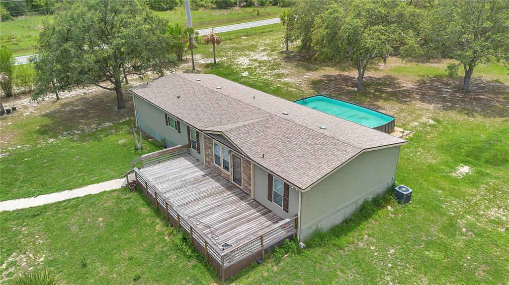 7565 Dewey Robbins Road Howey-in-the-Hills, FL 34737 - Photo 2 of 42 an aerial view of a house with a yard