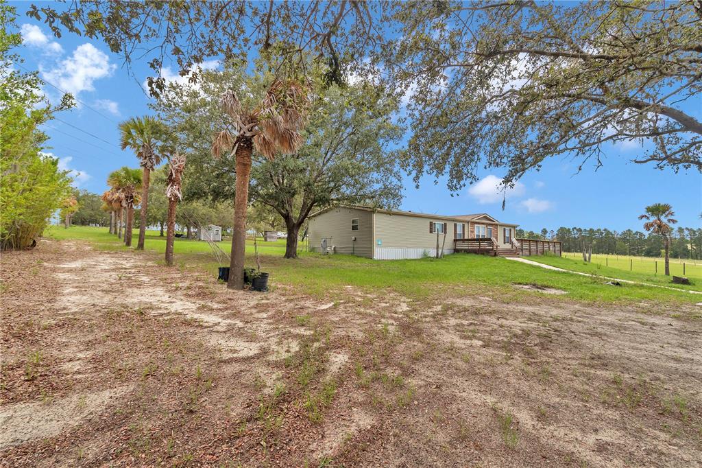 7565 Dewey Robbins Road Howey-in-the-Hills, FL 34737 - Photo 37 of 42 a view of a house with a big yard