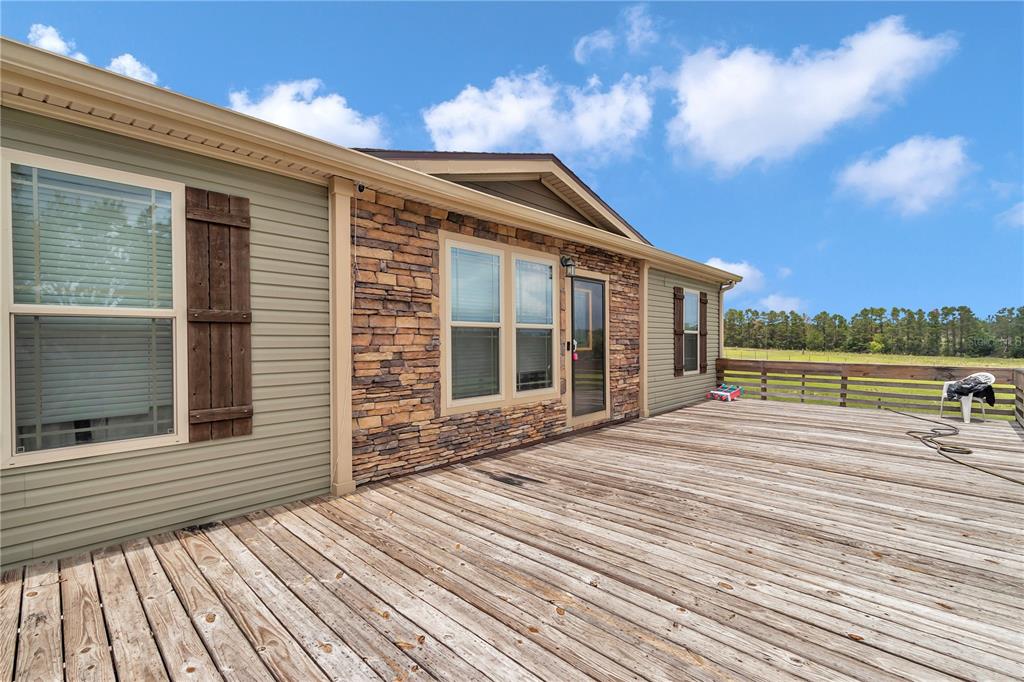 7565 Dewey Robbins Road Howey-in-the-Hills, FL 34737 - Photo 4 of 42 a view of a house with a terrace