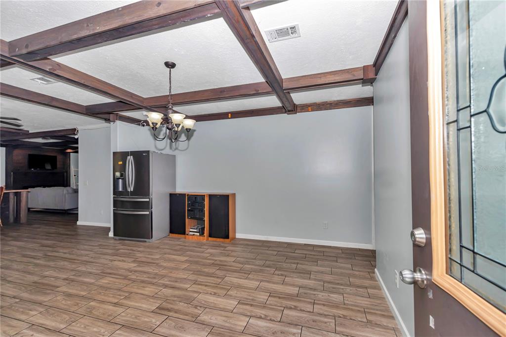7565 Dewey Robbins Road Howey-in-the-Hills, FL 34737 - Photo 6 of 42 a view of a livingroom with a ceiling fan window and stairs