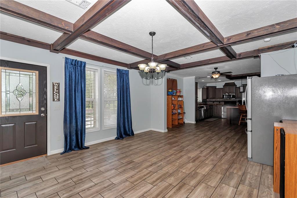 7565 Dewey Robbins Road Howey-in-the-Hills, FL 34737 - Photo 8 of 42 a view of a hallway with a kitchen