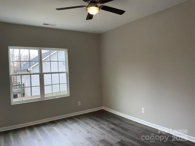 384 Washington Street, Unit 6 Cramerton, NC 28032 - Photo 6 of 10 an empty room with wooden floor fan and windows