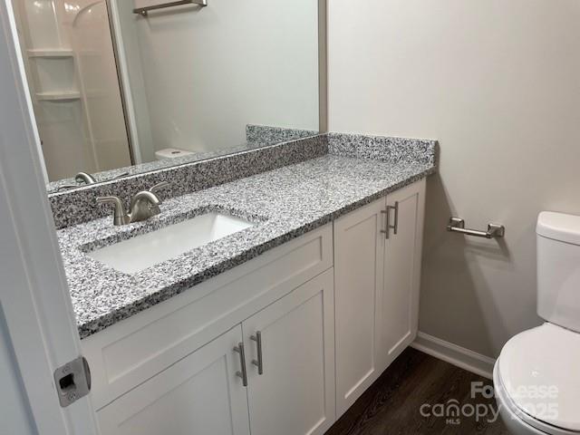 384 Washington Street, Unit 6 Cramerton, NC 28032 - Photo 9 of 10 a bathroom with a granite countertop sink a toilet and a mirror