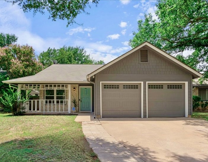 7610 Navarro Place Austin, TX 78749 - Photo 1 of 1 a front view of a house with a garden and plants