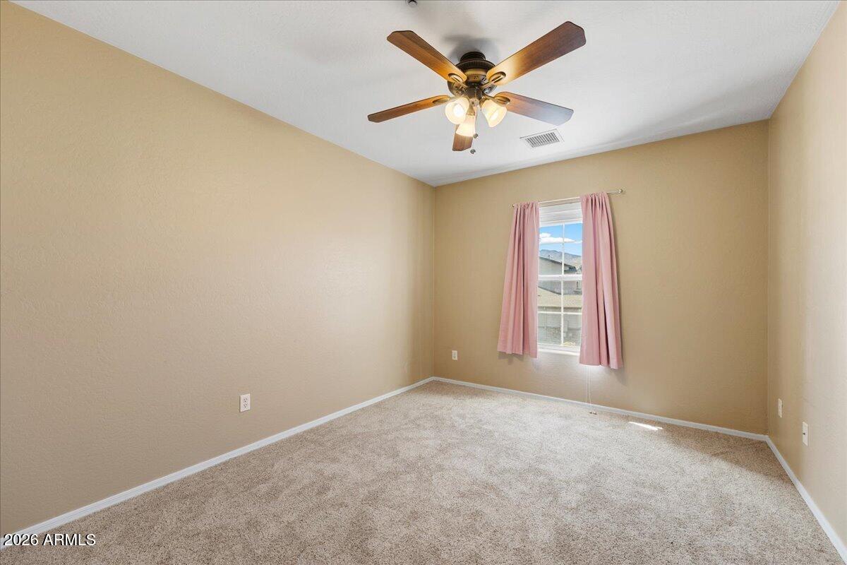 813 Alfonse Road Clarkdale, AZ 86324 - Photo 12 of 41 an empty room with windows and fan