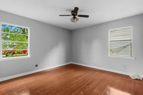 a view of room with window and ceiling fan
