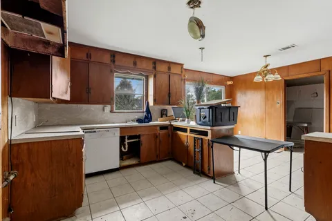 a kitchen with granite countertop a sink counter top space appliances and cabinets