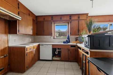 a kitchen with stainless steel appliances granite countertop a sink stove and microwave