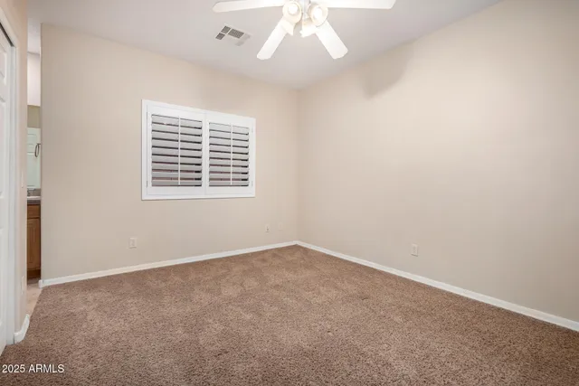 a view of a field with some trees in front of it