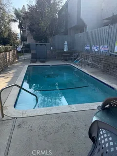 a view of a refrigerator in kitchen counter top space wooden floor and a cabinets