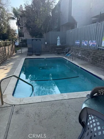 a view of a refrigerator in kitchen counter top space wooden floor and a cabinets