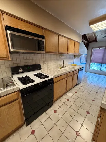 a kitchen with stainless steel appliances granite countertop a sink and cabinets