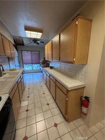 a bathroom with a granite countertop sink and a toilet
