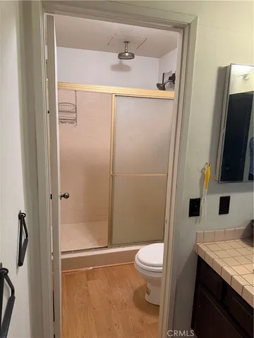 a bathroom with a sink a toilet and mirror