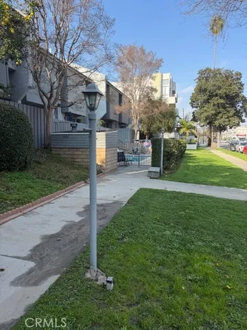 a view of a street with a building and a park
