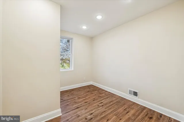 a view of room with wooden floor and fan