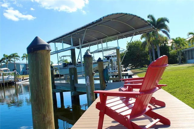 a view of a chairs and table in patio with a barbeque