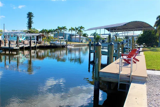 a kitchen with a refrigerator a stove a sink and a dining table