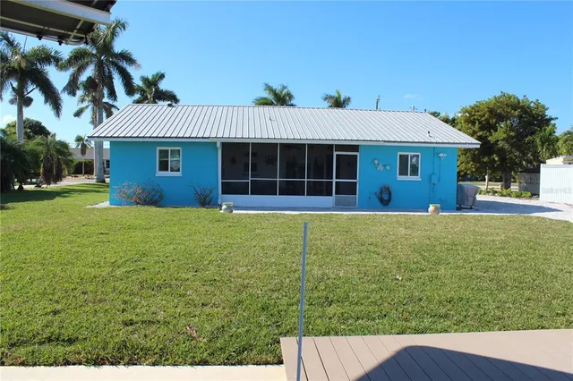 a kitchen with kitchen island granite countertop a sink appliances and cabinets