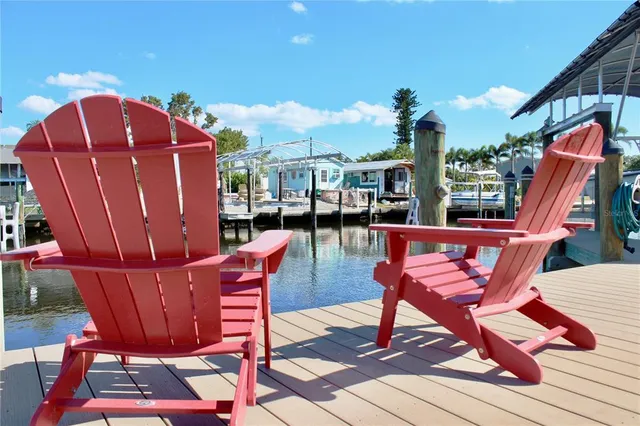 a living room with furniture kitchen view and a wooden floor