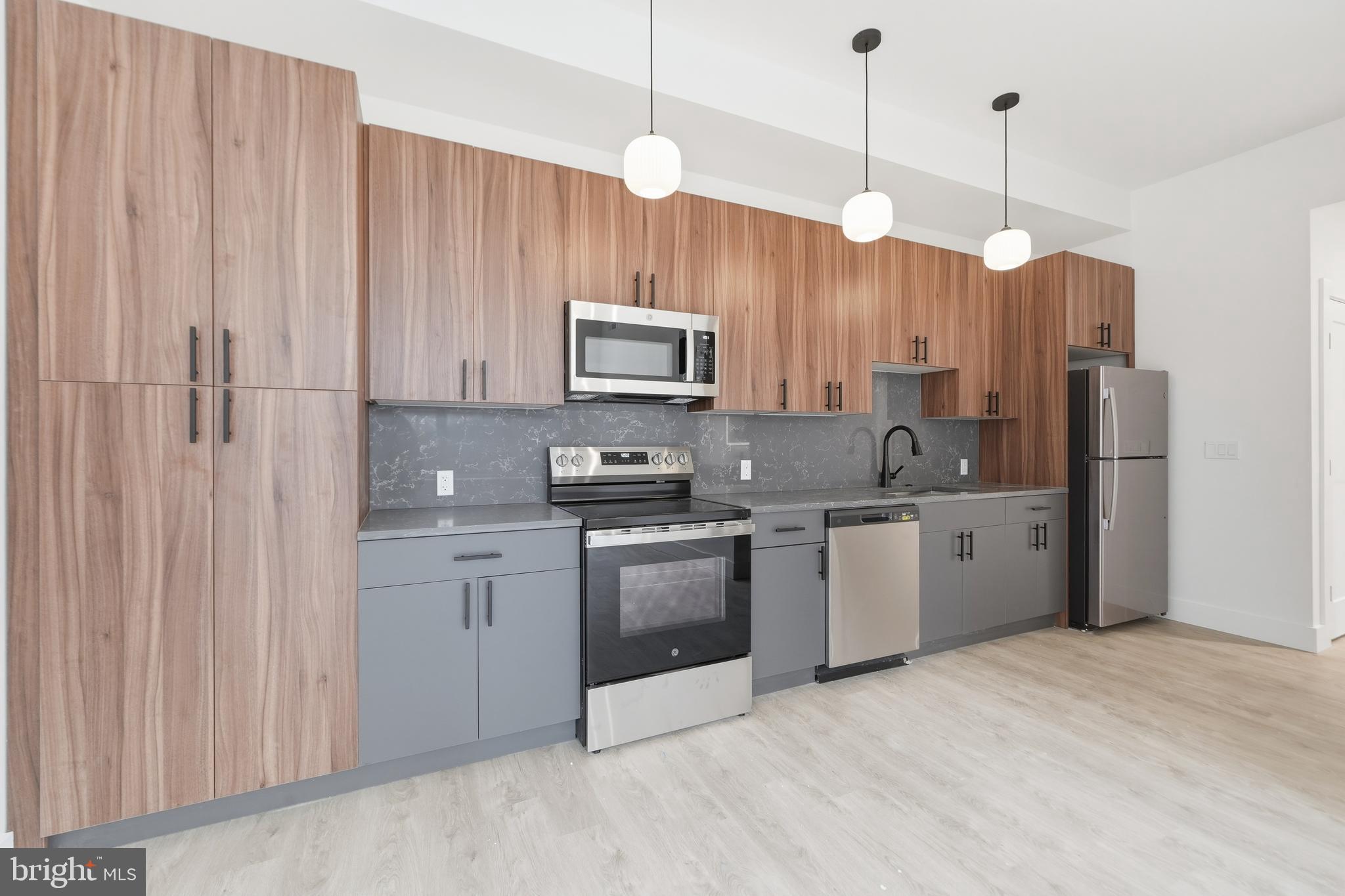 326 North 12th Street, Unit 506 Philadelphia, PA 19107 - Photo 15 of 22 a kitchen with stainless steel appliances granite countertop a stove a sink and a refrigerator