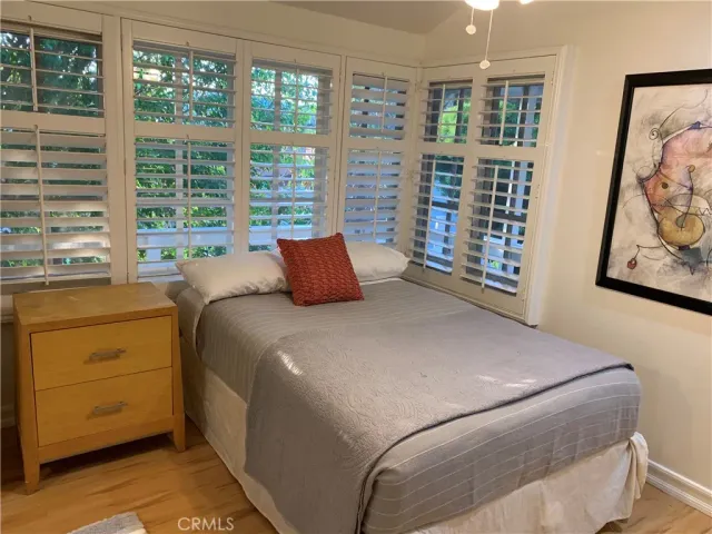 a bedroom with a large bed and a window