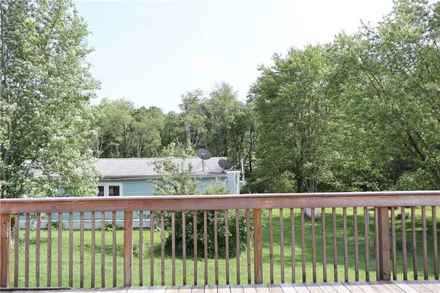 a view of a balcony with yard