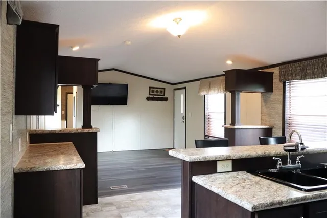 a view of a livingroom with wooden floor and windows