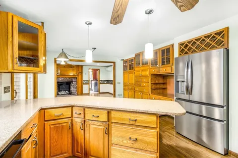 a kitchen with a refrigerator a sink and cabinets