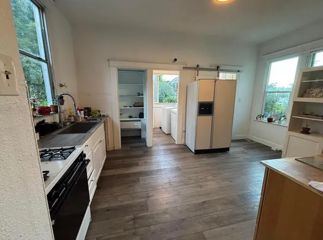 a kitchen with stainless steel appliances a stove a sink and a refrigerator