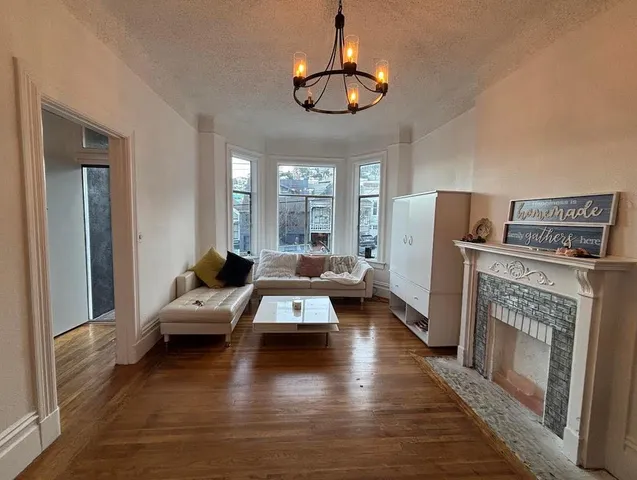a living room with furniture or chandelier and a fireplace