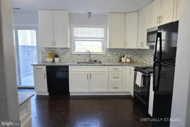 a kitchen with stainless steel appliances a refrigerator stove and sink