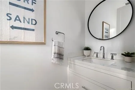 a bathroom with a double vanity sink a mirror and a bathtub