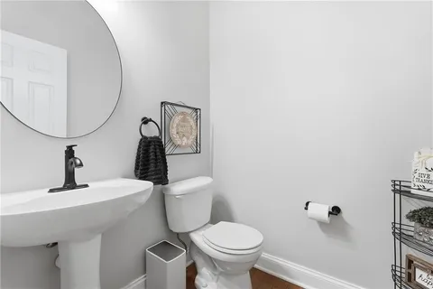 a bathroom with a toilet a sink and mirror