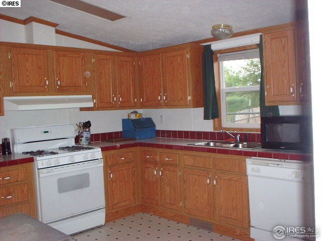 108 East Douglas Road Fort Collins, CO 80524 - Photo 4 of 12 a kitchen with a stove sink and cabinets