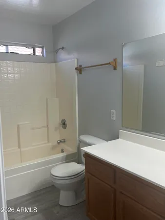 a bathroom with a toilet a sink a mirror and bathtub