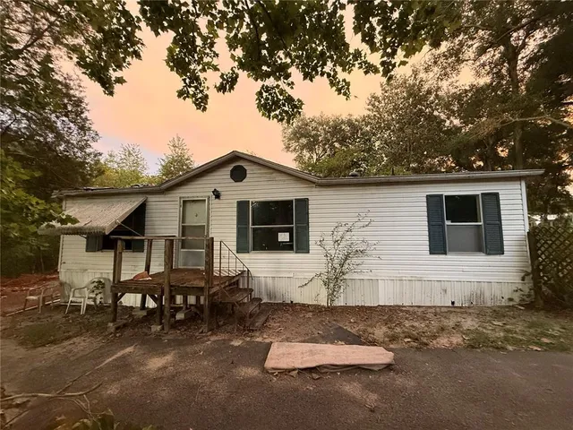 a front view of house with yard outdoor seating and barbeque oven