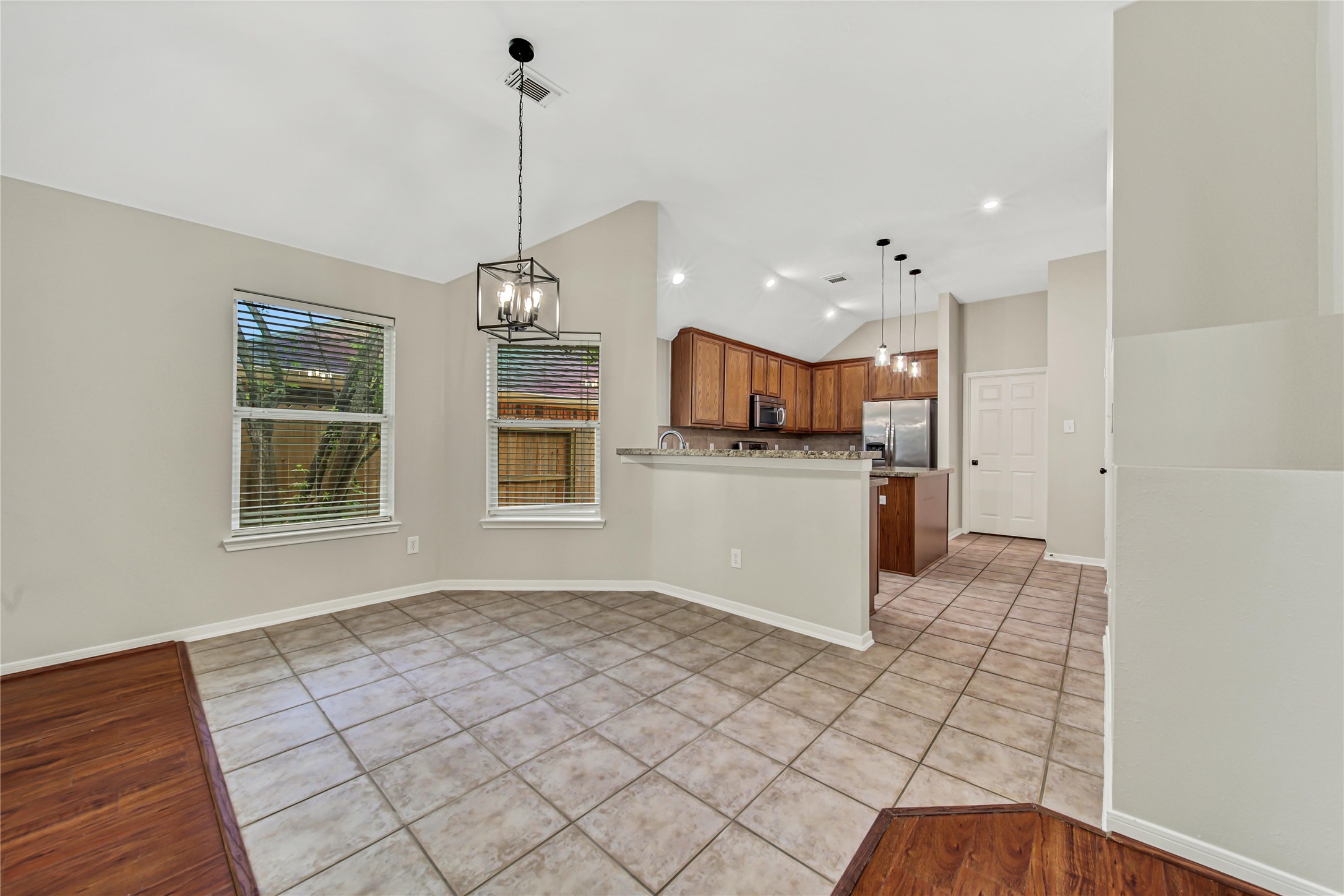14526 Red Tailed Hawk Lane Houston, TX 77044 - Photo 14 of 40 a kitchen with stainless steel appliances granite countertop a stove top oven a sink dishwasher and a wooden floor